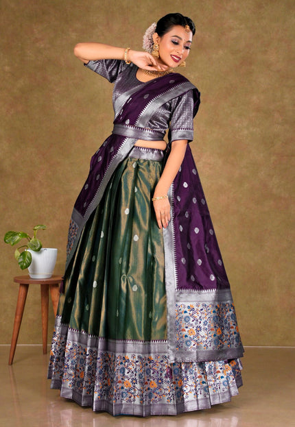 Woman in a traditional purple and green lehenga choli with dupatta