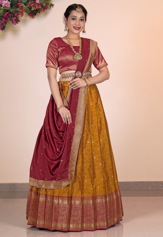 Woman wearing a maroon and yellow traditional Lehenga Choli outfit