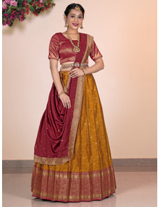 Woman wearing a maroon and yellow traditional Lehenga Choli outfit