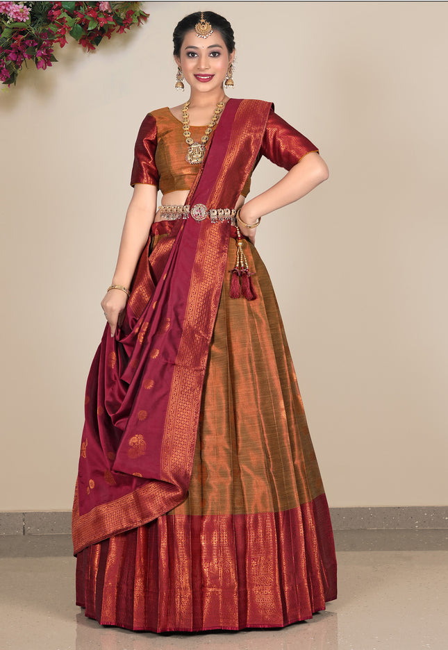 Woman wearing a traditional maroon and gold lehenga