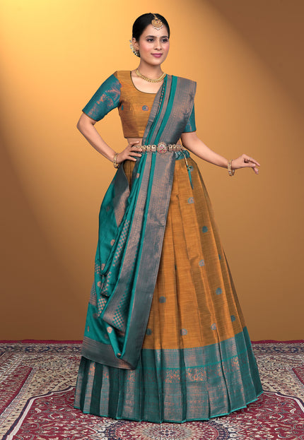 Woman wearing a traditional lehenga choli with a Musterd and green color
