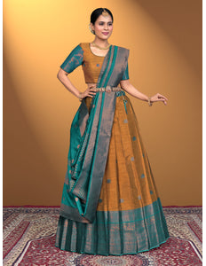 Woman wearing a traditional lehenga choli with a Musterd and green color