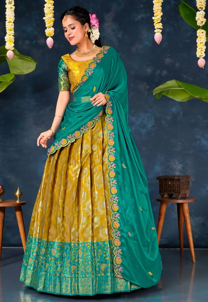 Woman in a green and yellow traditional lehenga choli with dupatta