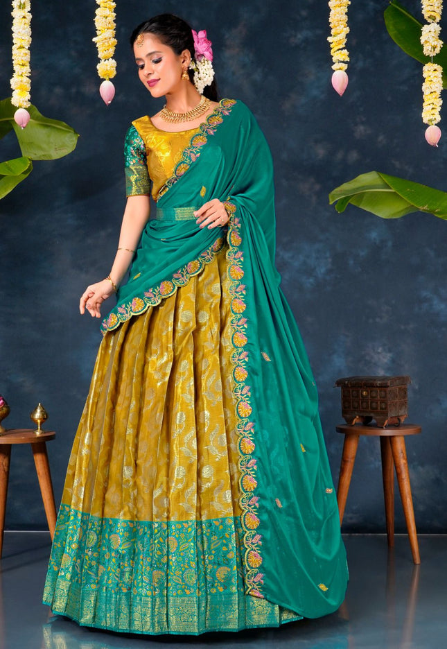 Woman in a green and yellow traditional lehenga choli with dupatta