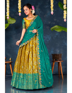 Woman in a green and yellow traditional lehenga choli with dupatta