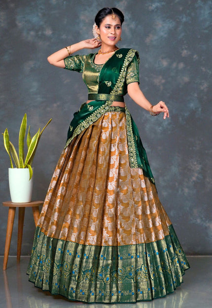 Woman wearing a traditional green and musterd lehenga choli with dupatta