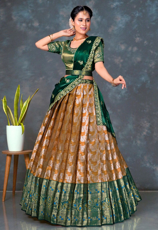 Woman wearing a traditional green and musterd lehenga choli with dupatta