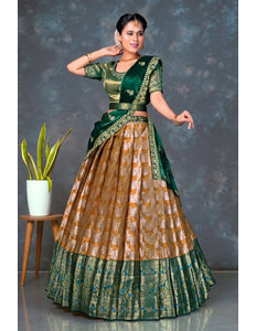 Woman wearing a traditional green and musterd lehenga choli with dupatta