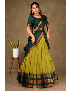 Woman wearing a green and musterd lehenga choli with dupatta