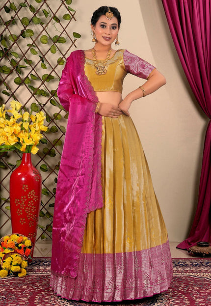 Woman in a yellow and pink traditional lehenga choli with dupatta