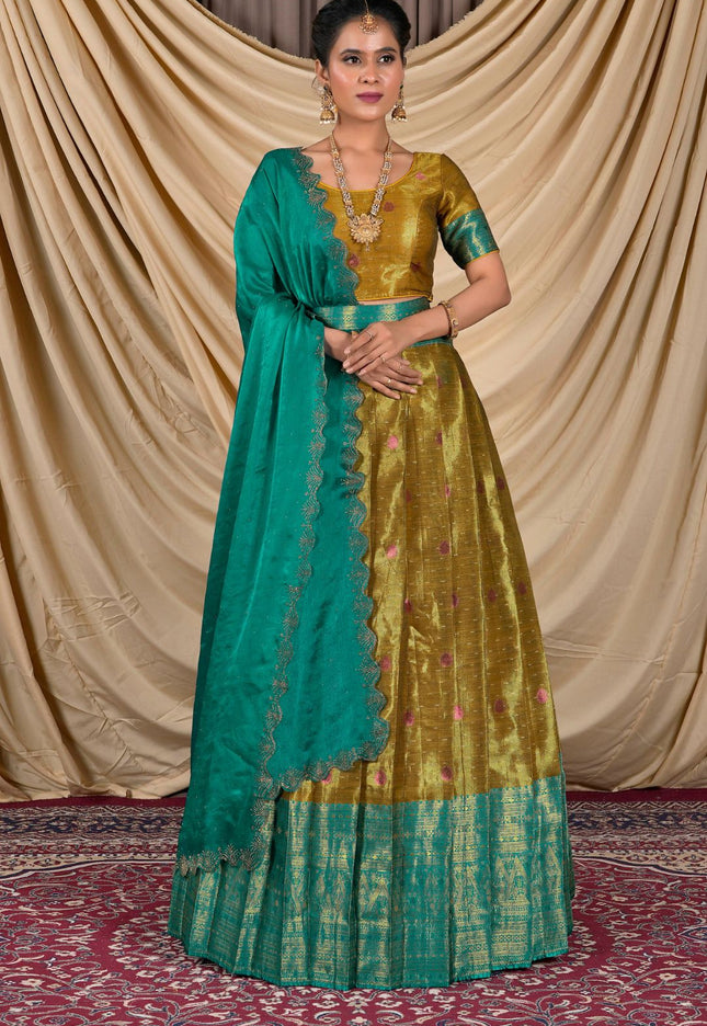 Woman wearing a traditional green and musterd lehenga with a matching blouse