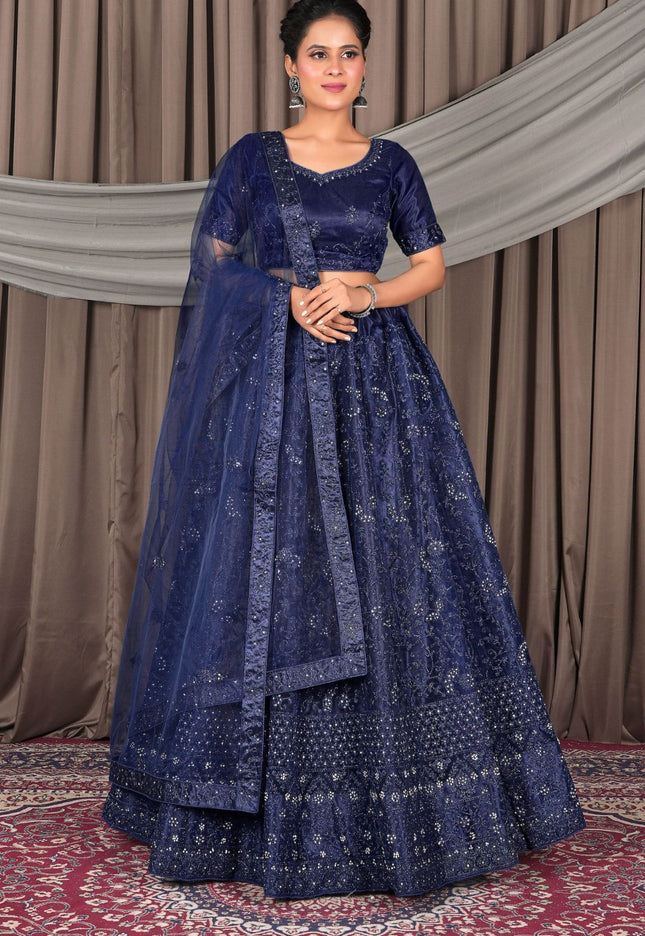 Woman wearing a traditional blue embroidered lehenga choli