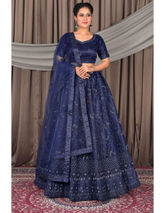 Woman wearing a traditional blue embroidered lehenga choli