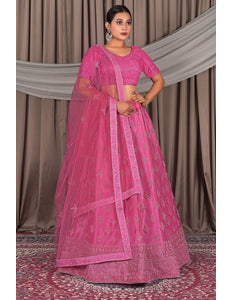 Woman wearing a pink traditional outfit with a matching dupatta