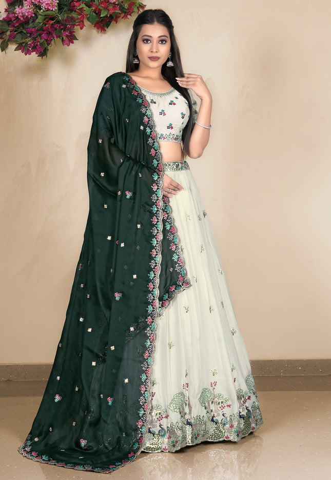 Woman wearing a dark green and white embroidered lehenga choli