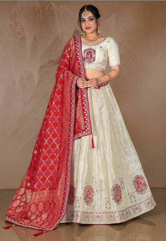 Woman wearing a traditional white and red embroidered lehenga choli