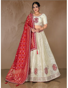 Woman wearing a traditional white and red embroidered lehenga choli