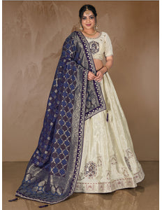 Woman wearing a traditional white and blue embroidered lehenga choli