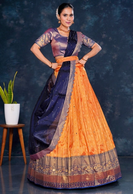 Woman wearing a traditional outfit with an orange and Blue Half Saree