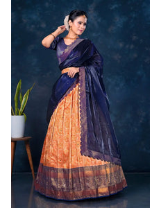Woman wearing a traditional lehenga with a dark blue and orange pattern