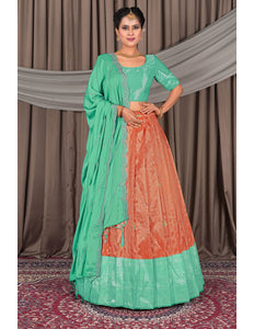Woman wearing a traditional green and orange lehenga choli