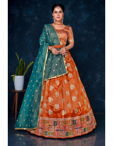 Woman wearing an orange and green traditional half saree