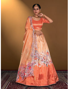 Woman wearing a peach lehenga choli with floral patterns