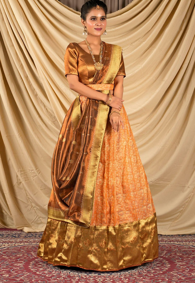 Woman wearing a traditional orange and gold lehenga choli with dupatta