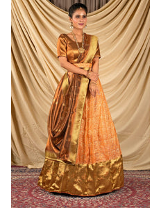 Woman wearing a traditional orange and gold lehenga choli with dupatta