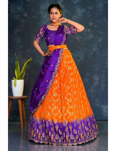 Woman wearing a traditional purple and orange lehenga choli