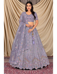 Woman wearing a traditional purple embroidered outfit