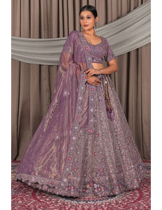 Woman wearing a traditional purple embroidered outfit