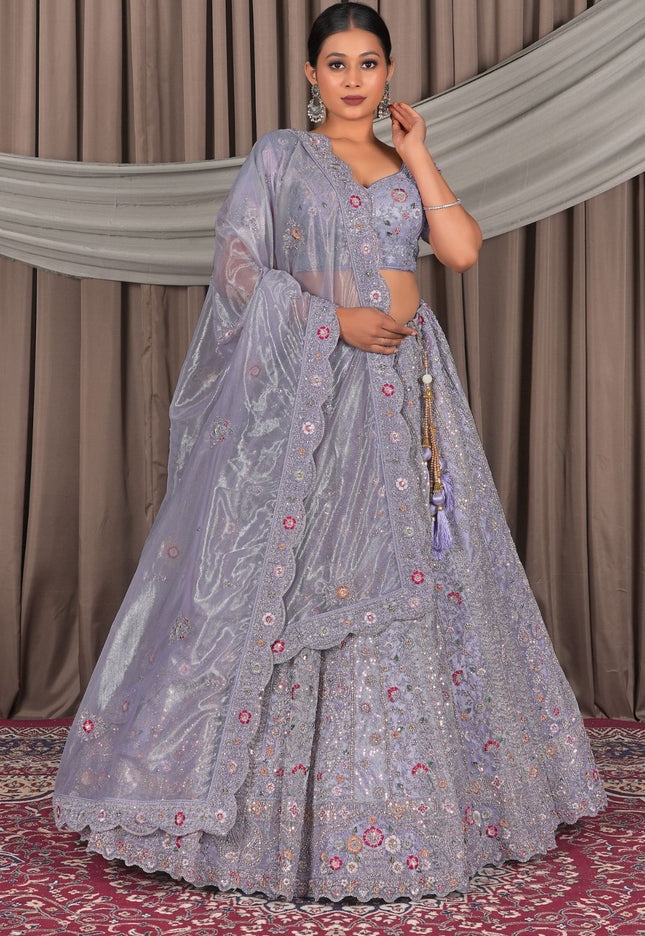 Woman in a traditional lavender embroidered lehenga with a matching dupatta
