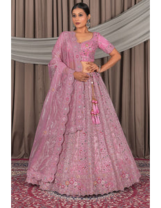 Woman in a pink traditional outfit with floral patterns