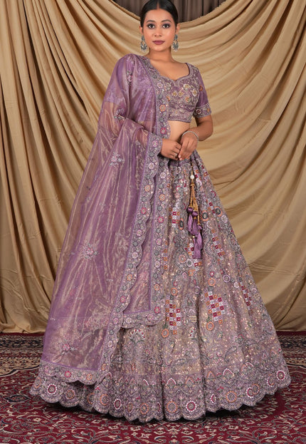 Woman wearing a traditional purple embroidered lehenga choli