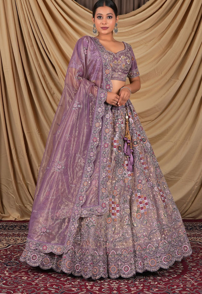 Woman wearing a traditional purple embroidered lehenga choli