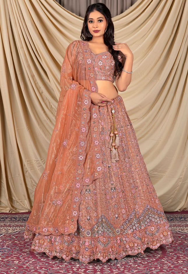 Woman wearing a traditional peach lehenga with floral patterns