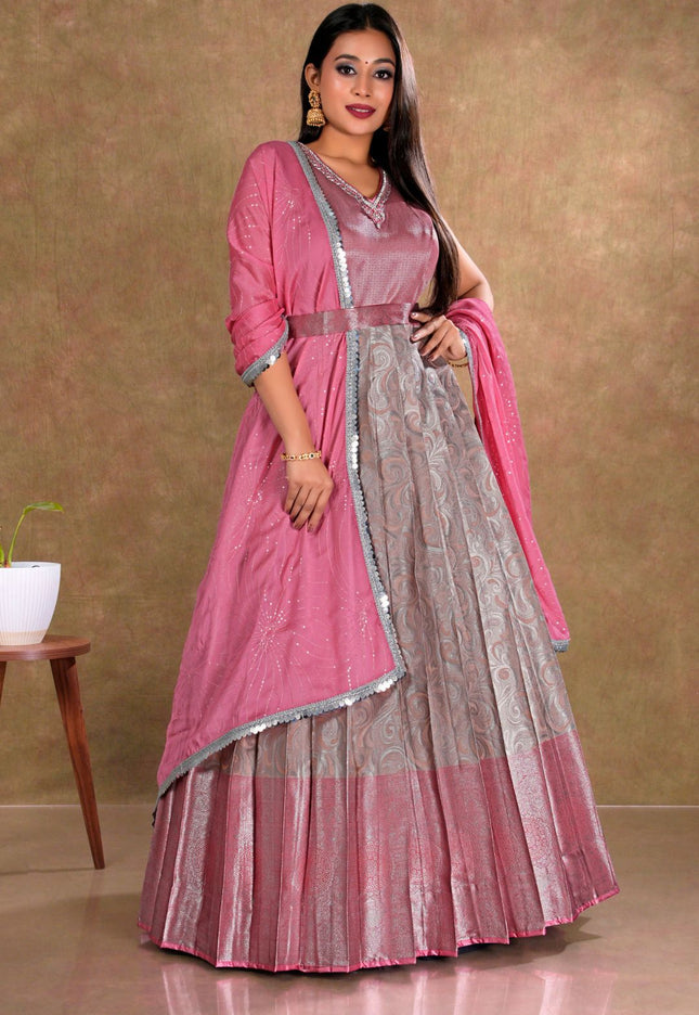 Woman wearing a pink and peach traditional gown with dupatta
