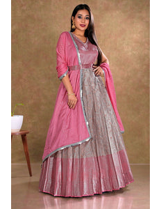 Woman wearing a pink and peach traditional gown with dupatta