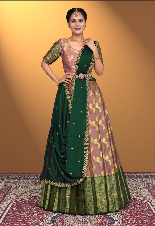 Woman wearing a traditional green and pink lehenga choli