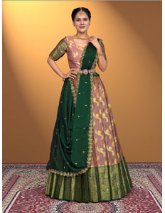 Woman wearing a traditional green and pink lehenga choli