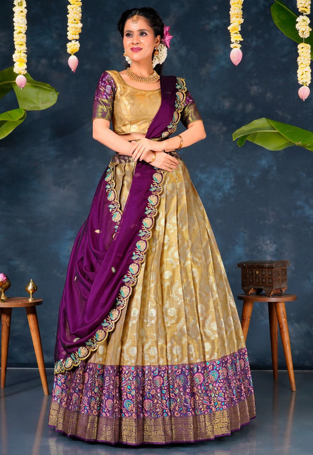 Woman in a traditional gold and purple lehenga choli with dupatta