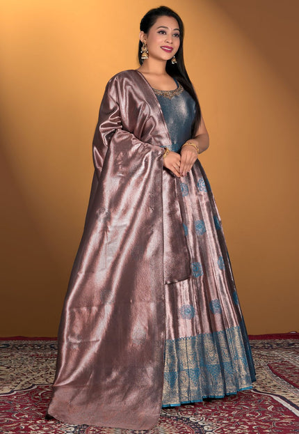 Woman wearing a long, flowing dress with a metallic sheen