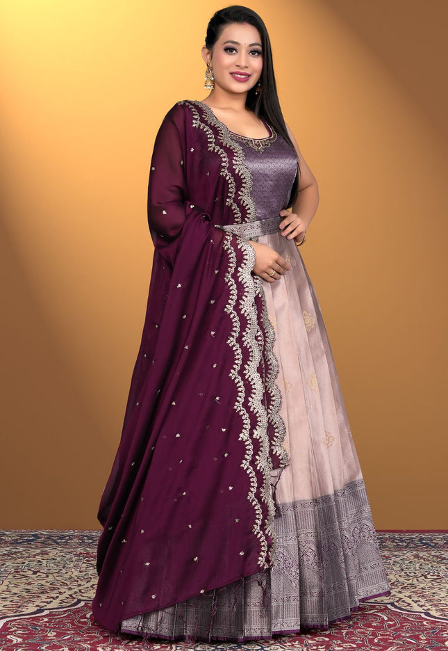 Woman wearing a traditional outfit with a purple and pink dress