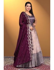 Woman wearing a traditional outfit with a purple and pink dress