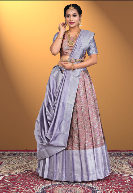 Woman wearing a traditional outfit with a purple lehenga and pink blouse