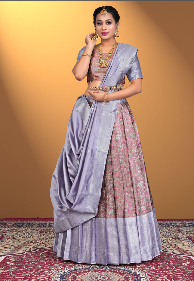 Woman wearing a traditional outfit with a purple lehenga and pink blouse