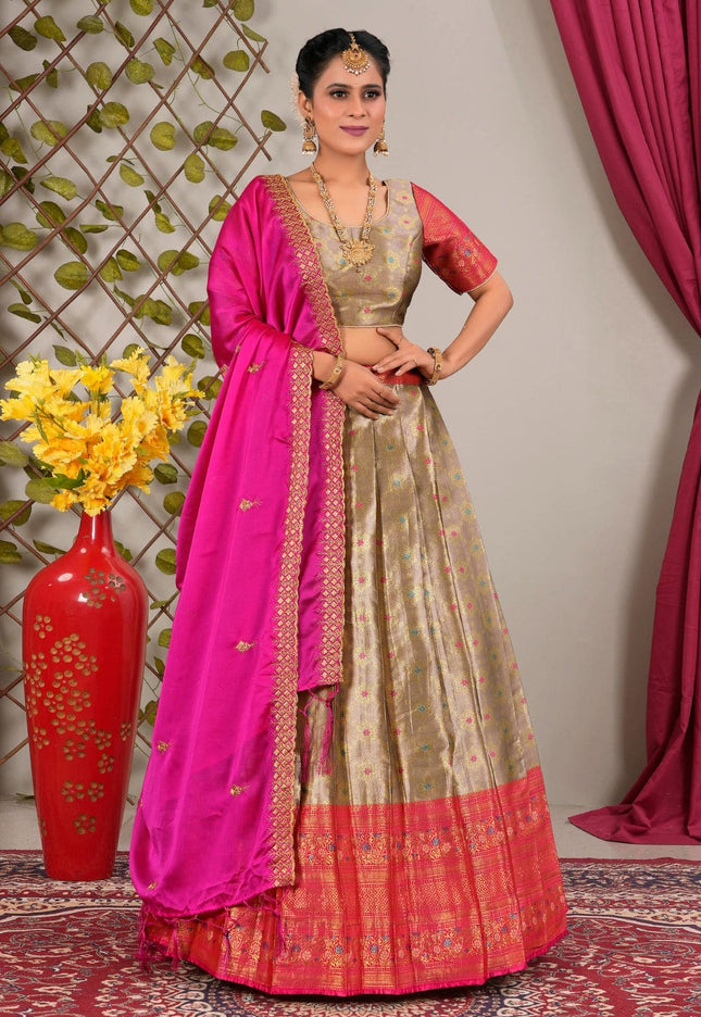 Woman in a traditional outfit with a pink and peach lehenga choli with dupatta