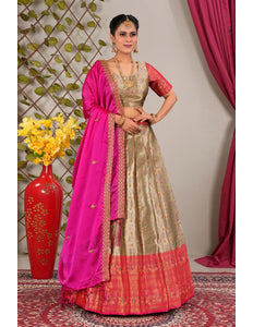 Woman in a traditional outfit with a pink and peach lehenga choli with dupatta