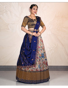 Woman wearing a traditional outfit with a blue and patterned skirt